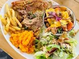 Plated pork chop with mashed pumpkin, chips, and garden salad